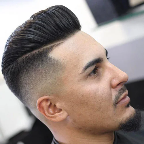 Hard-part skin fade with a swept pompadour, side profile