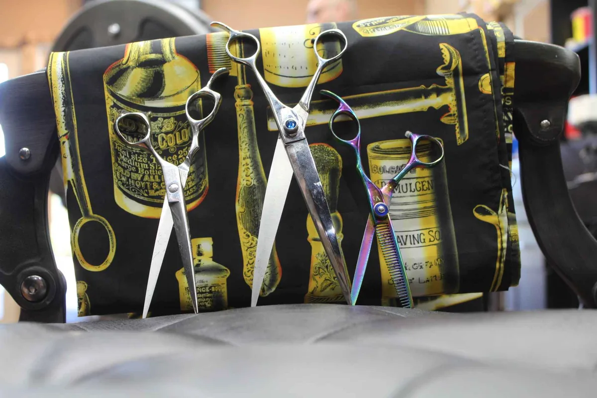 Shears resting on a barber chair inside the studio